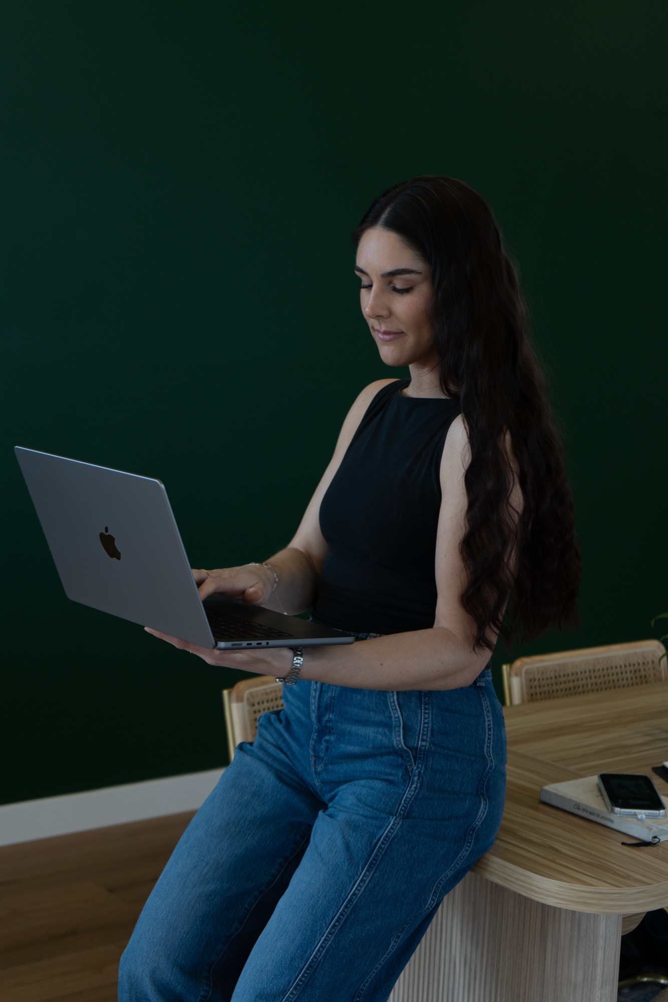 Allison Flynn holding a laptop, founder of Aligned Form